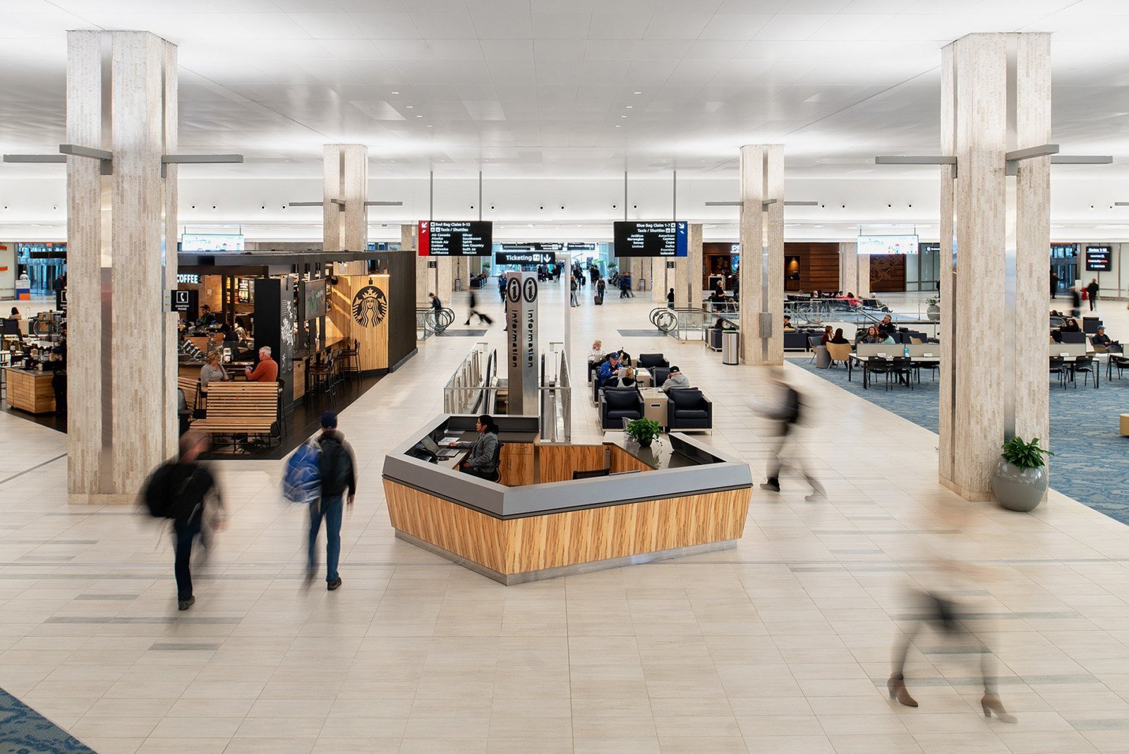 Busy airport terminal interior with travellers